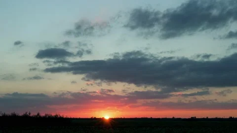 Colorful Sunset of the Sun Sets Over the Horizon in the Field of a Multi-Colored Stock Footage 161795541