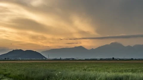 Colorful sunset time lapse over meadow, small town and Alps mountains Stock Footage 133901431