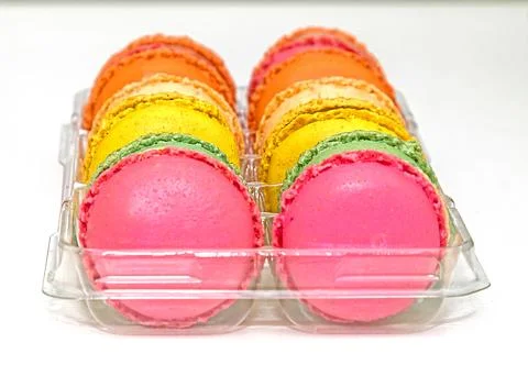 Colorful sweet macarons stack inside plastic box isolated 스톡 사진