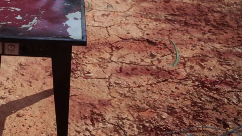 Colorful Table on Cracked Earth Under Bright Sunlight Creates a Stark Contrast Stock Footage 344927123