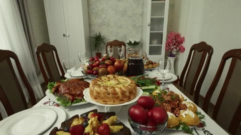 Colorful table setting with various traditional dishes and fruits arranged for a Stock Footage 332736943