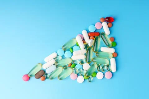Colorful tablets in the shape of a graph on a blue background Foto stock
