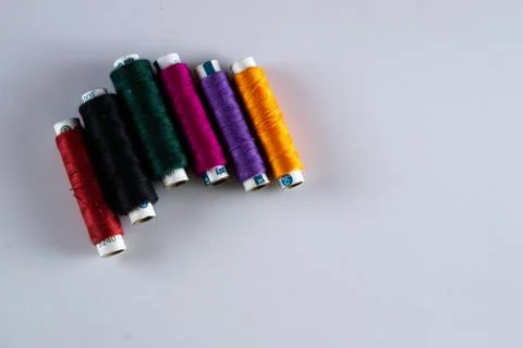 Colorful tailoring thread spools on a white table Stock Photos