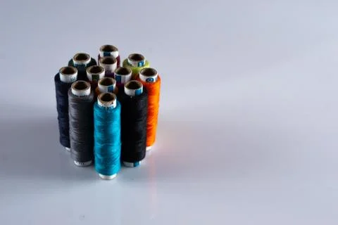 Colorful tailoring thread spools on a white table Stock Photos