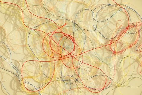 Colorful tangled threads on white surface. Abstract background Foto stock