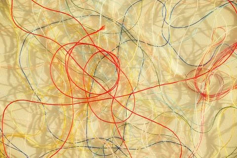 Colorful tangled threads on white surface. Abstract background Stock Photos