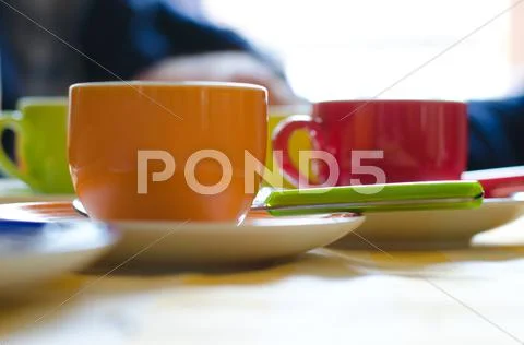 Colorful tea and coffee cups for breakfast Stock Photos
