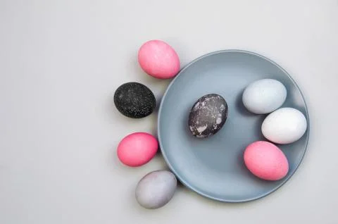 Colorful textured easter eggs on blue plate and near it. Eggs painted with Stock Photos