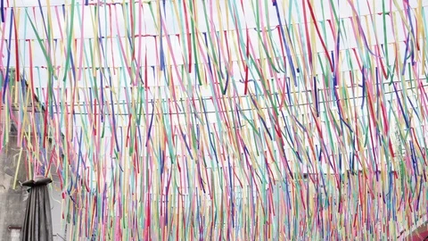 Colorful thin ribbons fluttering in wind against bright white sky over night  Stock-Footage 99922087