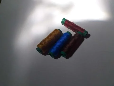 Colorful thread spool on white background Stock Photos