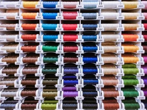 Colorful thread spools close up, sewing supplies Stock Photos