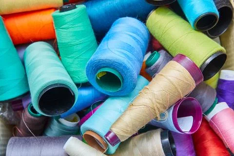 Colorful Thread Spools in Disarray Close-Up Stock Photos
