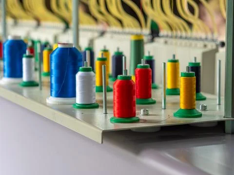 Colorful Thread Spools Mounted on Industrial Embroidery Machine Stock Photos