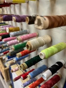 Colorful Thread Spools Organized on a Wall Display Stock Photos
