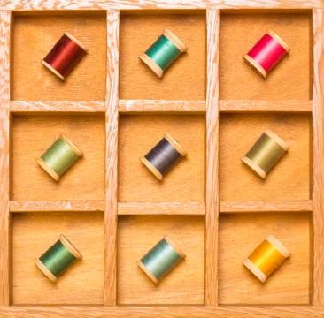 Colorful thread on spools in shadow box Stock Photos