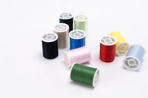Colorful Thread Spools on White Background - Sewing and Craft Supplies. Stock Photos