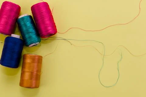 Colorful Thread Spools on Yellow Foto stock