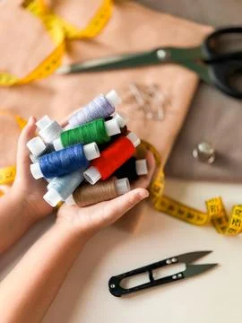 Colorful threads and sewing tools on tailors workspace Stock-Fotos