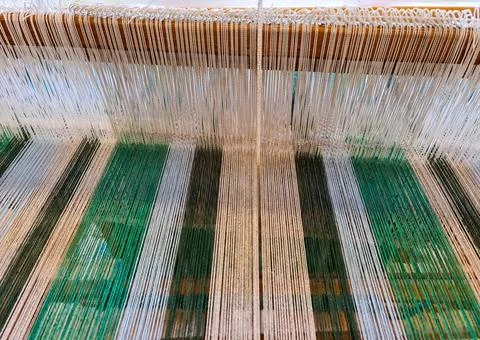 Colorful threads forming patterns on a weaving loom Stock Photos