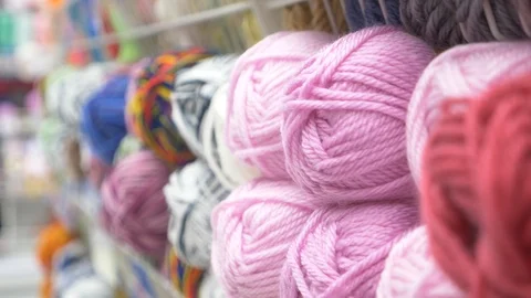 Colorful threads. Knitting pattern of colorful yarn wool on shopfront. Knitting Stock Footage 95422656