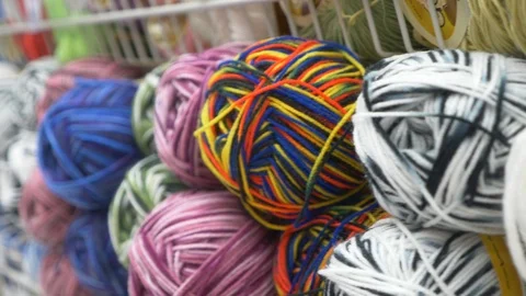 Colorful threads. Knitting pattern of colorful yarn wool on shopfront. Knitting Stock Footage 95422677
