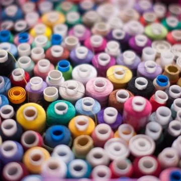 Colorful threads on a shelf at a sewing workshop, Stock Photos