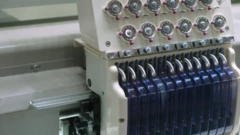 Colorful threads spin on industrial spools. Machine holds neatly arranged thr Stock Footage 331862273