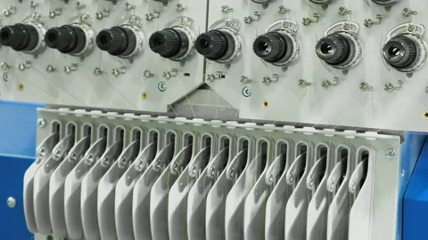 Colorful threads spin on industrial spools. Machine holds neatly arranged thr Stock Footage 331862292