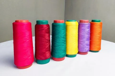 Colorful Threads Standing on a White Table Stock Photos
