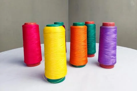 Colorful Threads Standing on a White Table Stock Photos