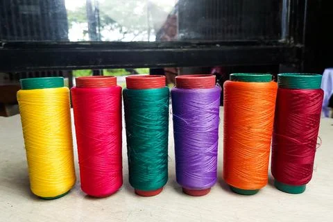 Colorful Threads Standing on a White Table 库存照片