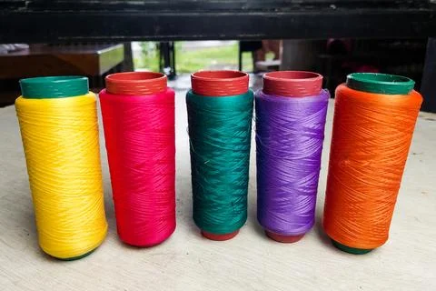 Colorful Threads Standing on a White Table 库存照片