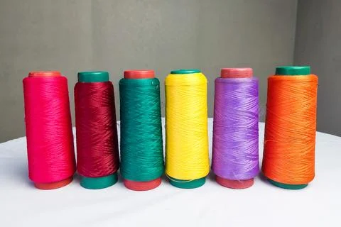 Colorful Threads Standing on a White Table Stock Photos