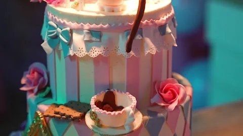 Colorful three-tier cake design inspired by a whimsical theme Stock Footage 304266399