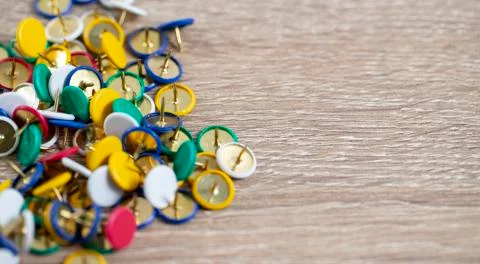 Colorful thumb tacks on the table Stock Photos