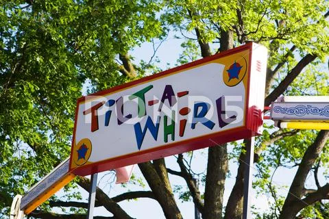 Colorful tilt a whirl sign Stock Photos