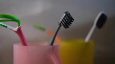 Colorful toothbrushes in bottles Stock Footage 115572944