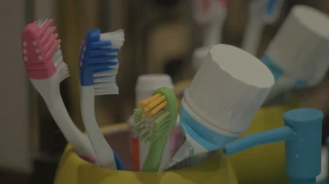 Colorful toothbrushes in a mug Stock Footage 43225277