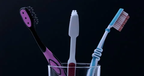Colorful toothbrushes rotating. Close up Stock Footage 131001139