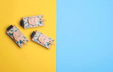 Colorful toy robot figures on a split yellow and blue background Stock Photos