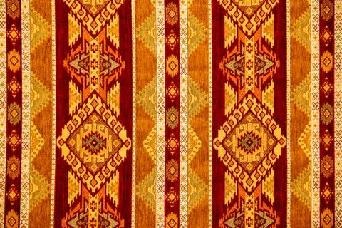 Colorful traditional textile pattern with geometric designs and rich hues Stock Photos