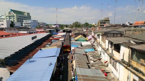 Colorful train passing through Maeklong railway market, A famous tourist at.. Video stock 304024595