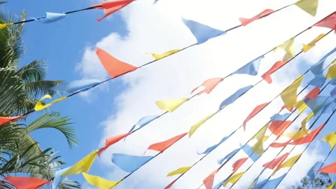 Colorful triangle bunting flags or banderitas hanging against blue sky Stock Footage 271610309