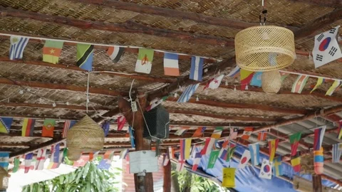 Colorful triangle flags blowing in the wind at a beach cafe. flags of different 動画素材 127149861
