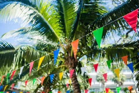 Colorful triangle flags hanging on ropes outdoor. High tall pole with colorfu Foto stock