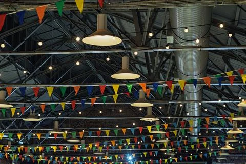 Colorful triangular flags and festive string lights create vibrant atmosphere Foto stock