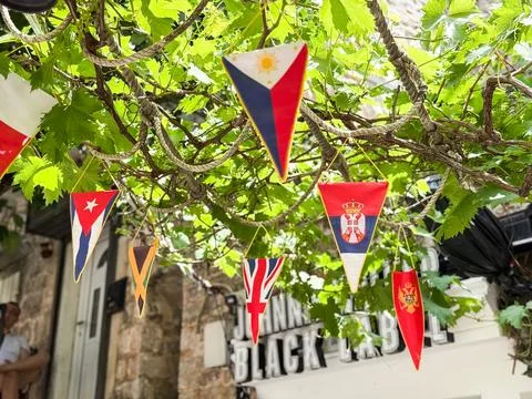 Colorful triangular flags countries hanging among green branches. Celebrati.. 写真素材