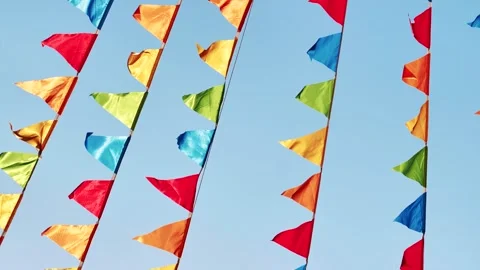 Colorful triangular flags hanging against a clear blue sky in Moscow Stock Footage 305713527