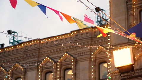 Colorful triangular flags of various colors and glowing Christmas garlands Stock Footage 168198279