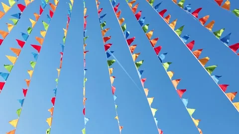 Colorful triangular flags waving in the wind against blue sky in Moscow Stock Footage 305711611